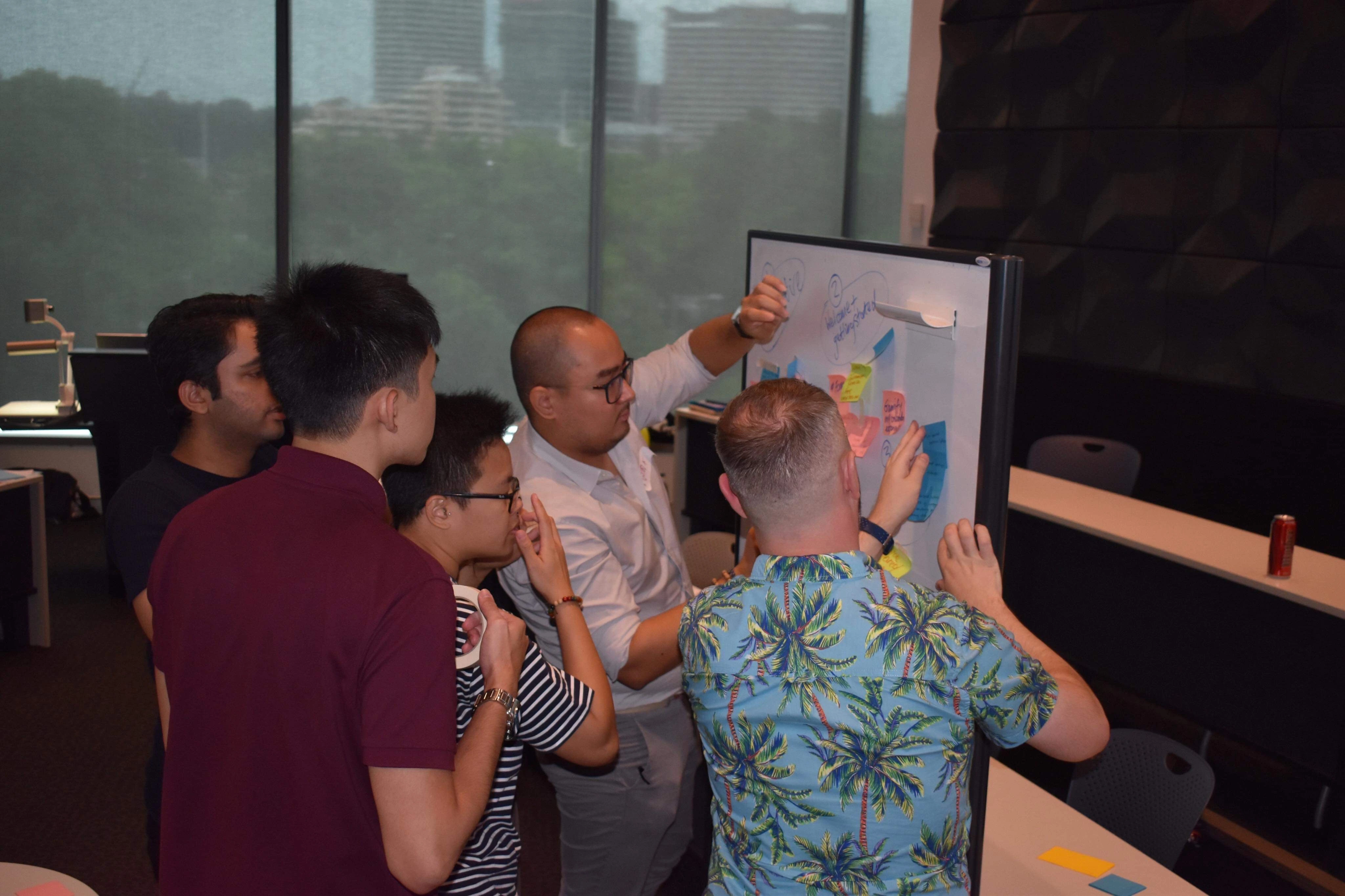 Winston being engaged in real-world business challenges at Suncorp's case competition.